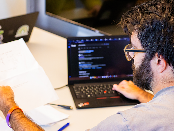 Staged photo of a computer science student reviewing code 